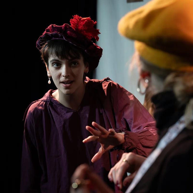 Orlando performer wearing a red feathered hat