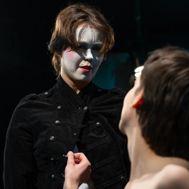 Orlando performer in a black costume and stage makeup