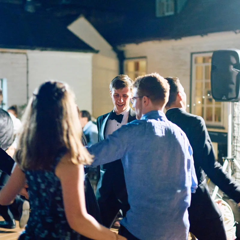 Guests talking outdoors in warm evening light